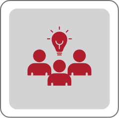 Icon of three people in red, with a red lightbulb above them, symbolizing collaboration, teamwork, or group brainstorming, on a gray square background with rounded corners.